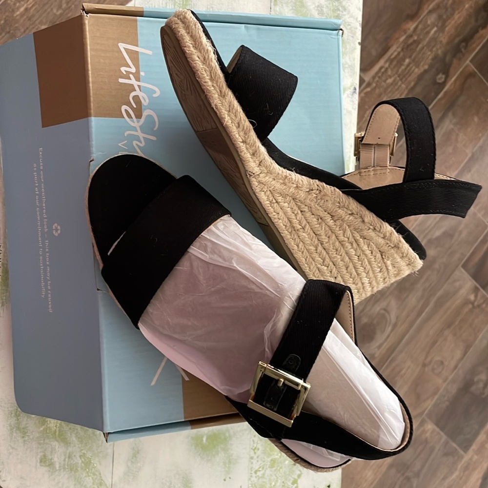 Never worn, black wedges perfect to dress up any outfit!